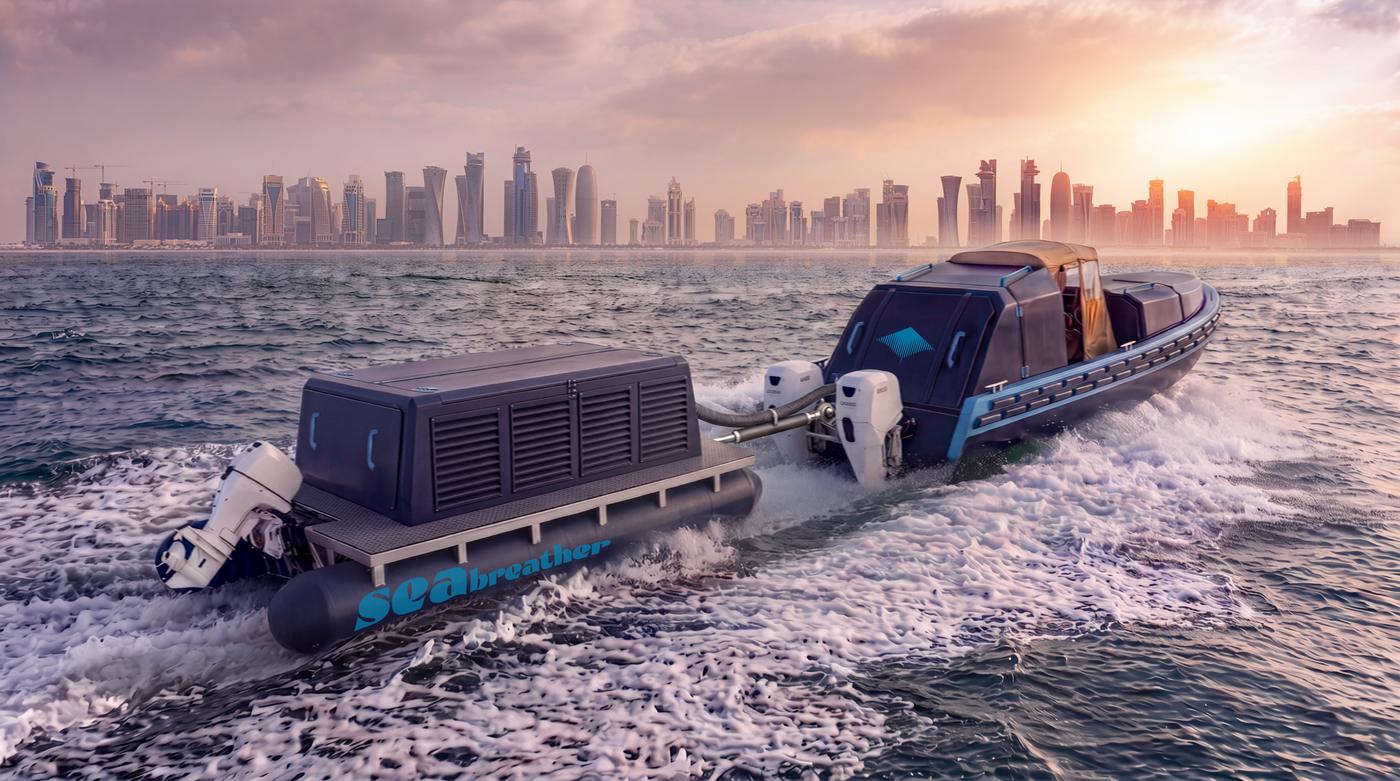 A Super SeaBreather with its gas barge alongside, running off the Doha skyline at sunset