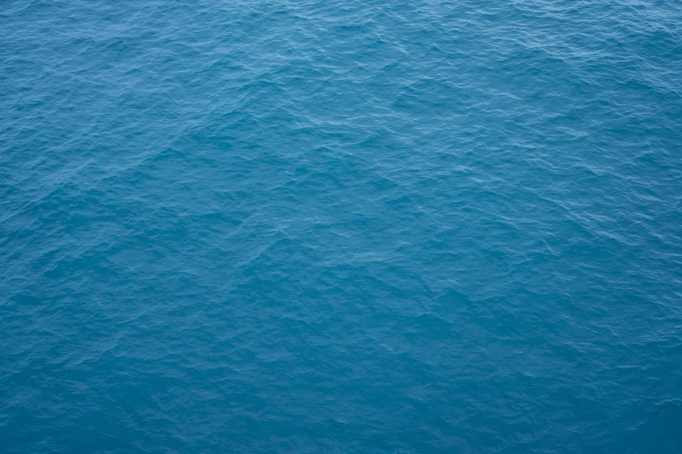 Open ocean surface in soft blue light, no horizon and no land